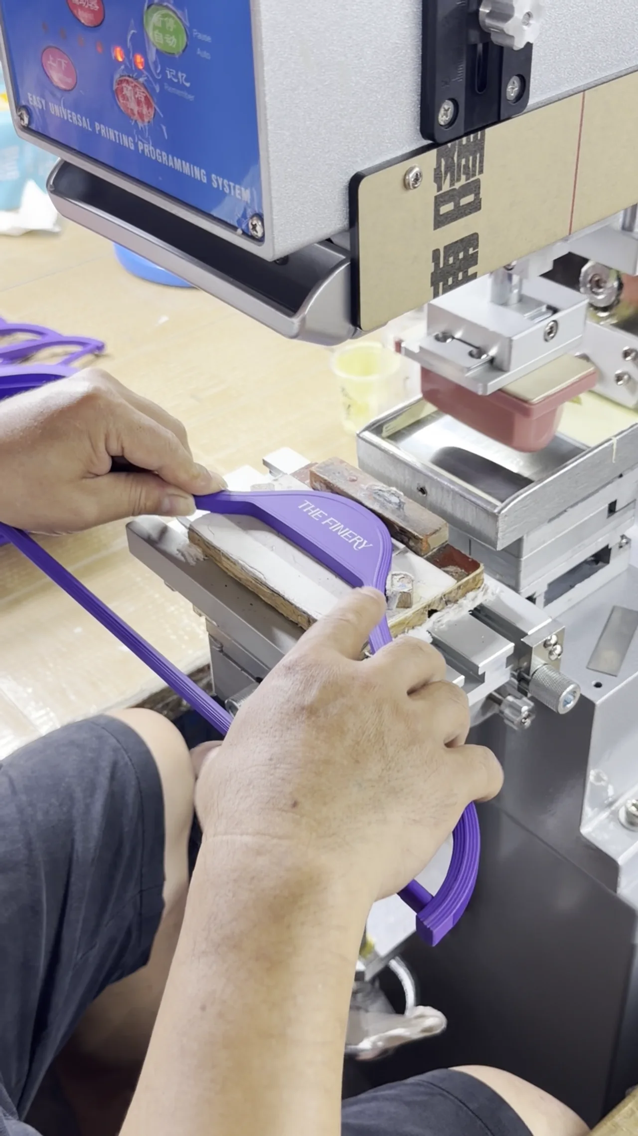 Logo being printed on a hanger in the workshop