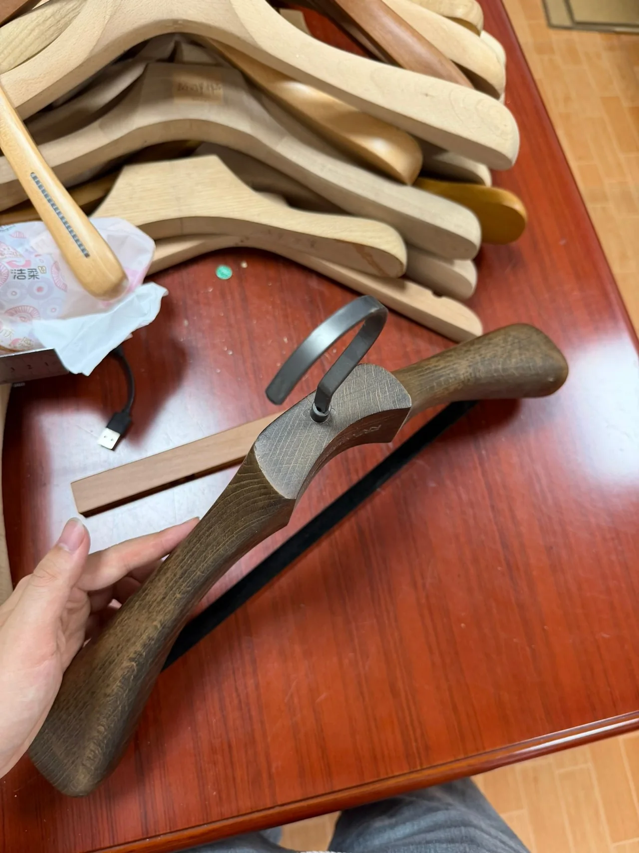Close-up of a wooden hanger’s shoulder profile